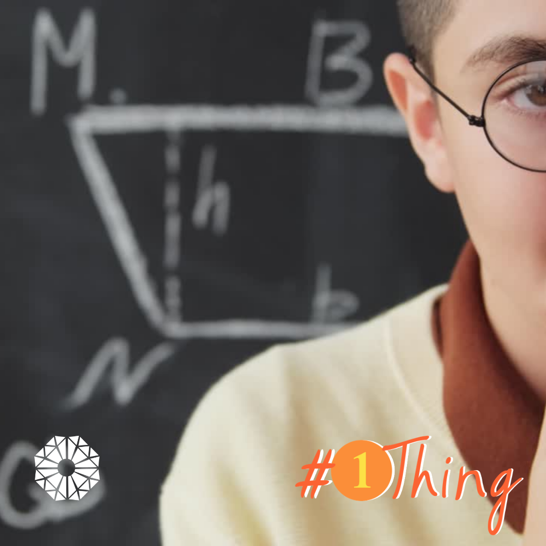 Young person in front of a school blackboard. #1Thing