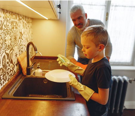 father and son washing dishes