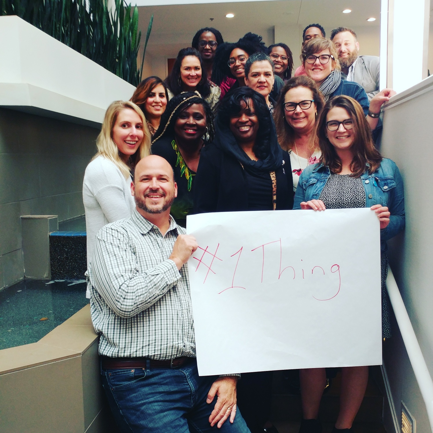 Members of the DVAP Advisory Board holding a #1Thing sign.